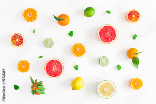 Fruit background. Colorful fresh fruits on white table. Orange, tangerine, lime, lemon, grapefruit. Flat lay, top view