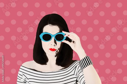 Photo in the style of pop art. Woman in a black and white striped top and blue sunglasses, pin up style.