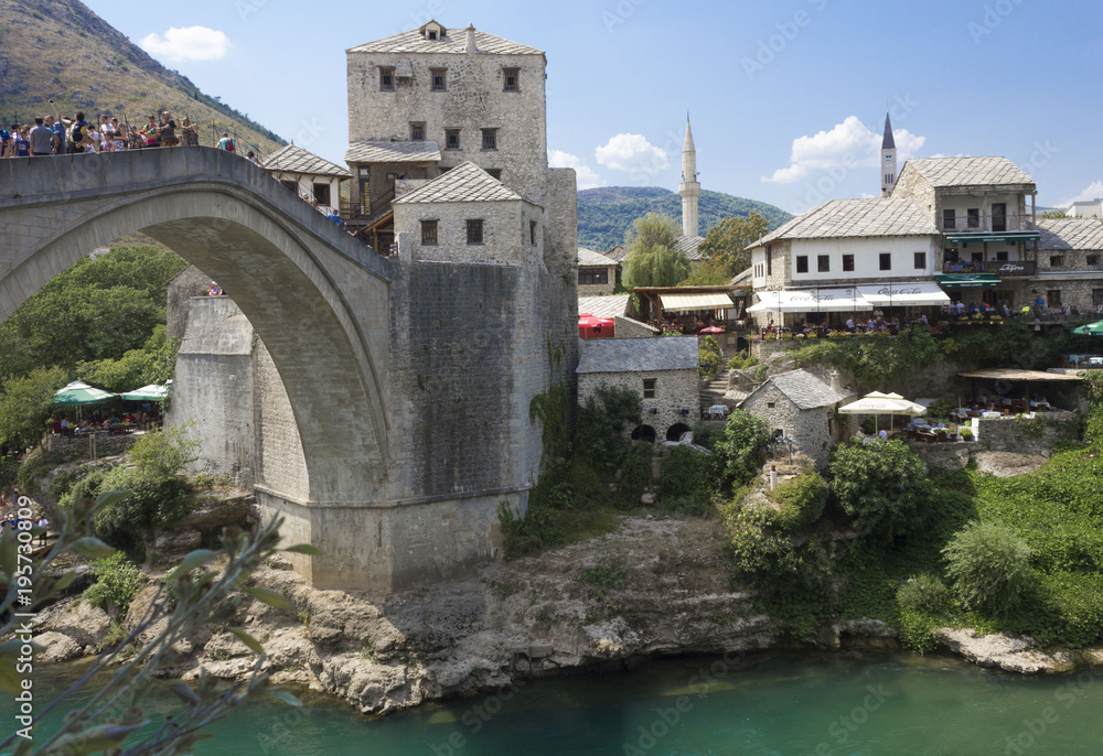 View of old Mostar bridge full of people in summer season