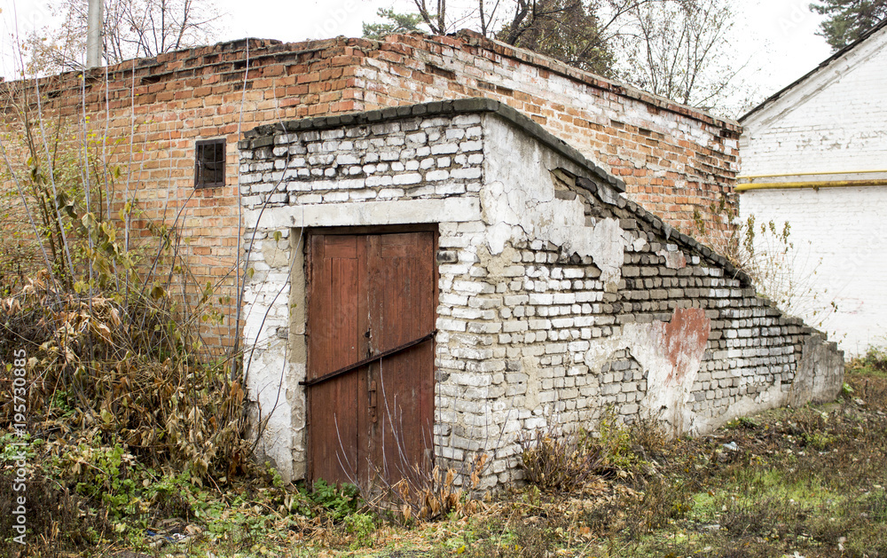Old abandoned cellar with a red door Old abandoned cellar with a red door