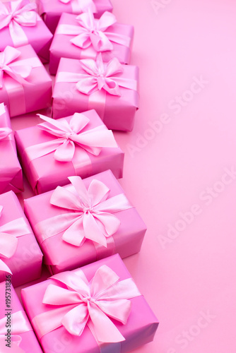 Decorative holiday gift boxes with pink color on pink background. © Evgeniia