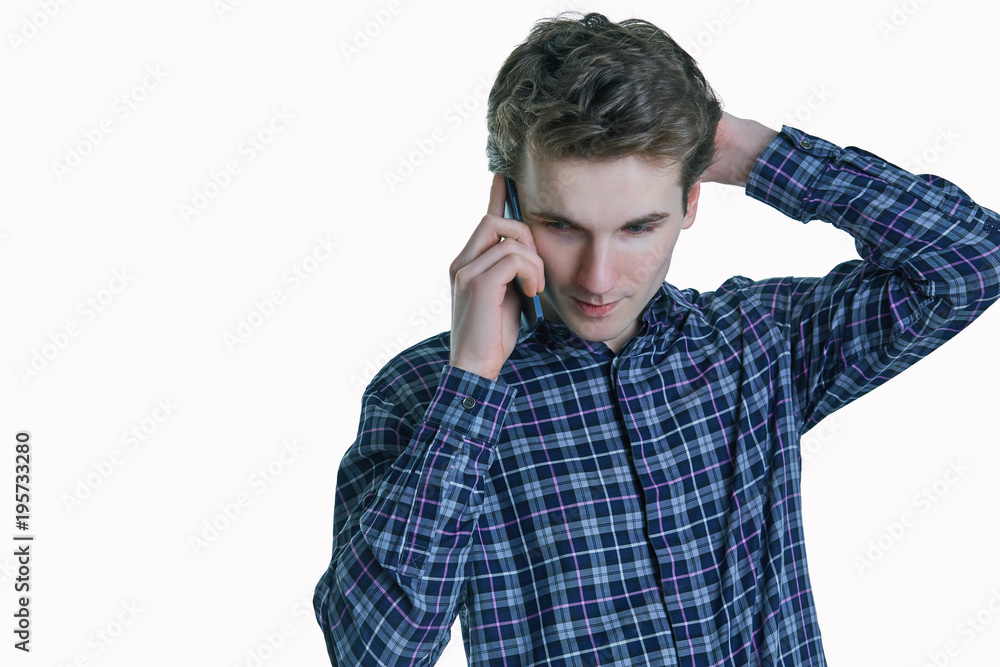 Close-up portrait of young, serious Caucasian business man, corporate employee, student talking on cell phone. Close-up portrait of young, serious Caucasian business man, corporate employee, student talking on cell phone.