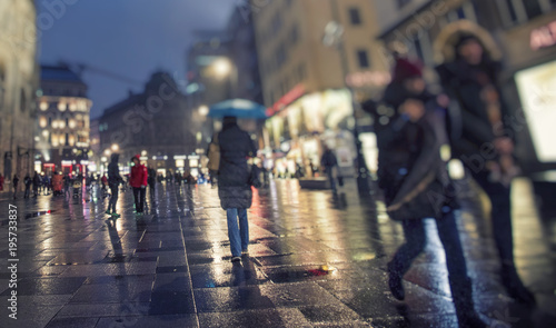 crowd of people walking on city streets ,rainy night 