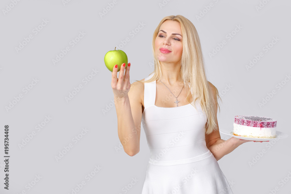 woman chooses between cake and apple woman chooses between cake and apple