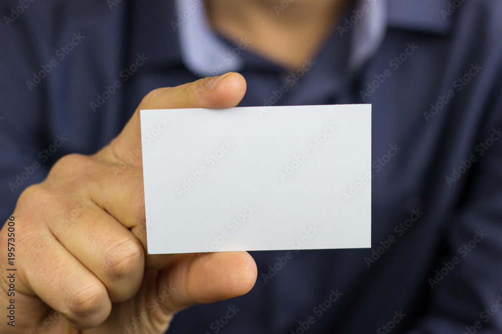 Man's hand showing business card Man's hand showing business card