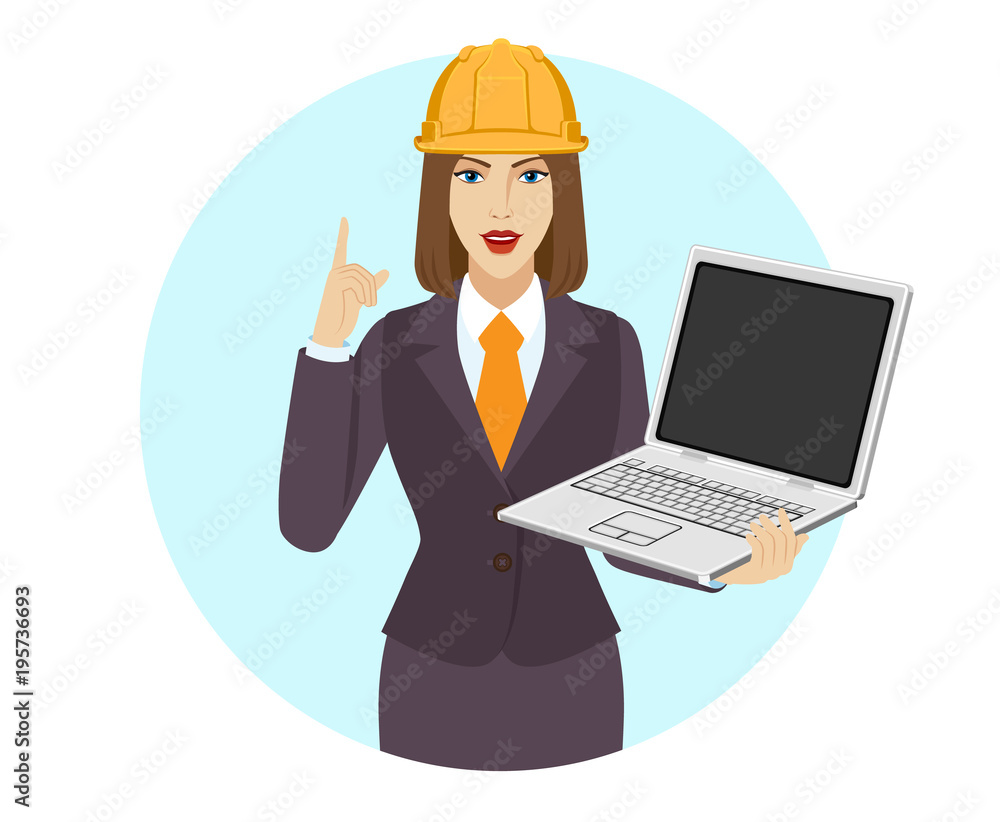 Businesswoman in construction helmet holding a laptop notebook and pointing up Businesswoman in construction helmet holding a laptop notebook and pointing up