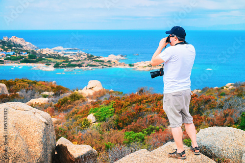 Man with camera taking photos Mediterranian sea Capo Testa photo