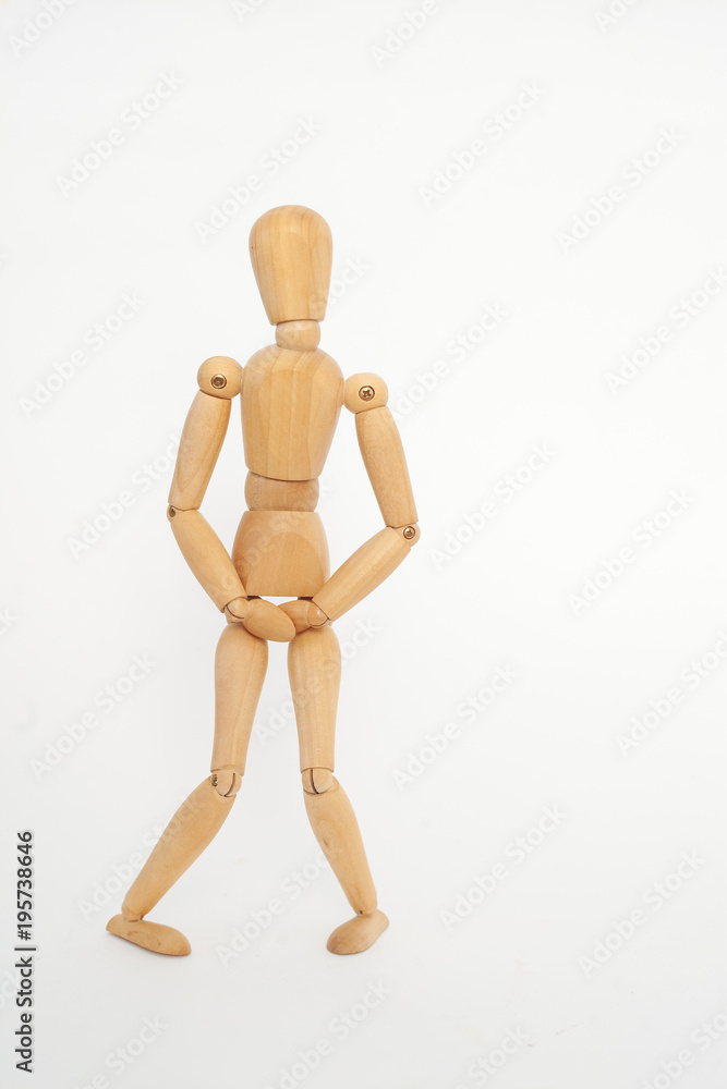 The wooden keeps below the belt. The concept of cystitis. On a white background. The wooden keeps below the belt. The concept of cystitis. On a white background.