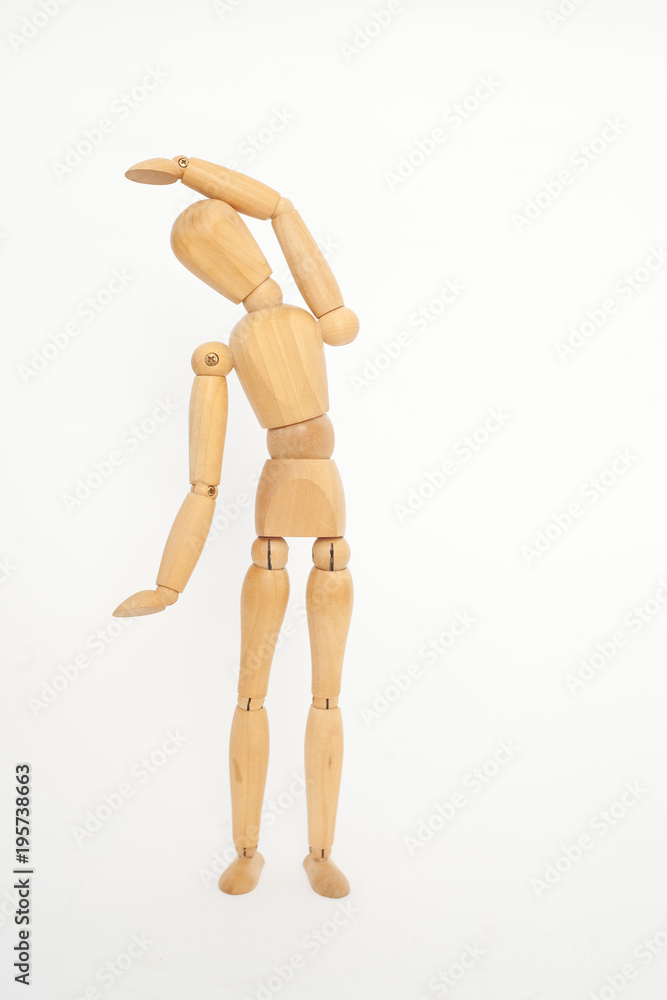A wooden manicure performs exercises of gymnastics. On a white background. A wooden manicure performs exercises of gymnastics. On a white background.