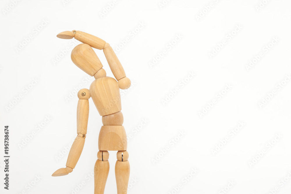 A wooden manicure performs exercises of gymnastics. On a white background. A wooden manicure performs exercises of gymnastics. On a white background.