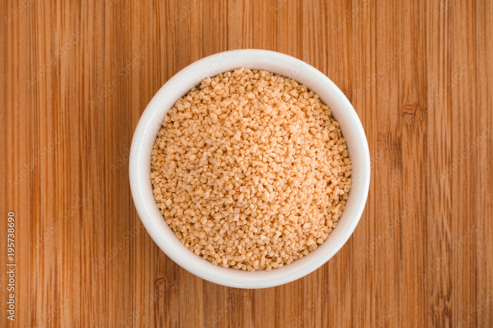 Soy lecithin in a bowl on a wooden background Soy lecithin in a bowl on a wooden background