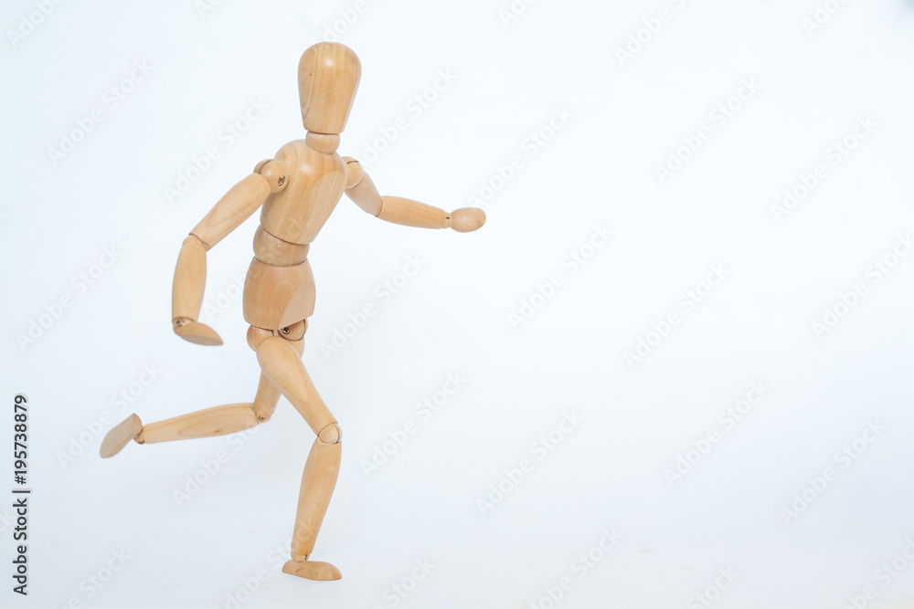 A wooden manicure performs exercises of gymnastics. On a white background. A wooden manicure performs exercises of gymnastics. On a white background.
