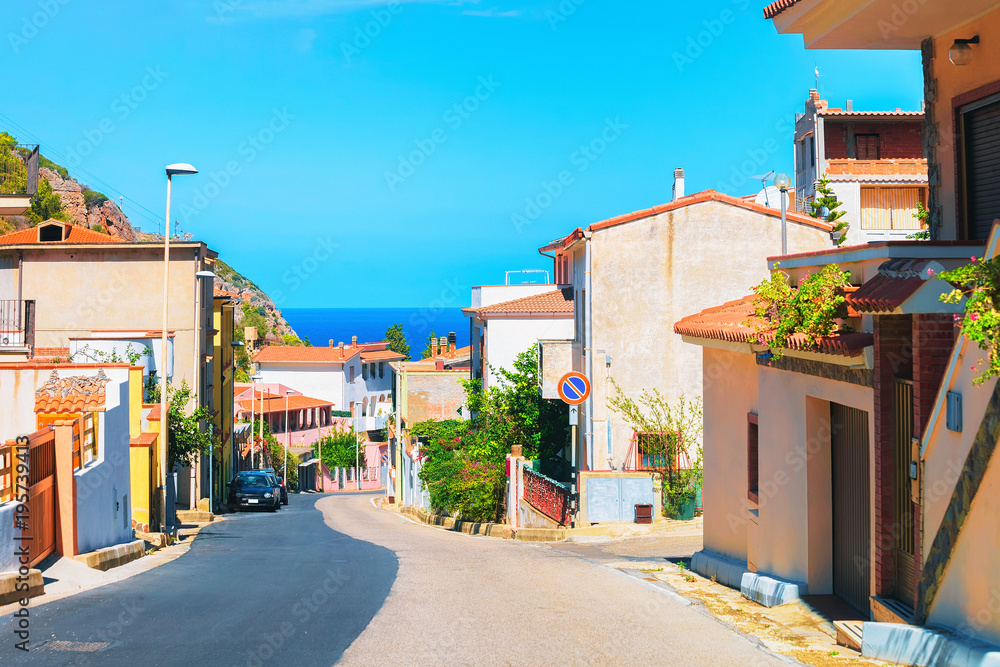 Street in Buggerru city with Mediterranean Sea South Sardinia
