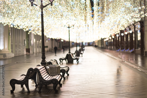 Christmas illumination of central street near the Moscow Kremlin with lights reflection on the road at night, Russia. photo