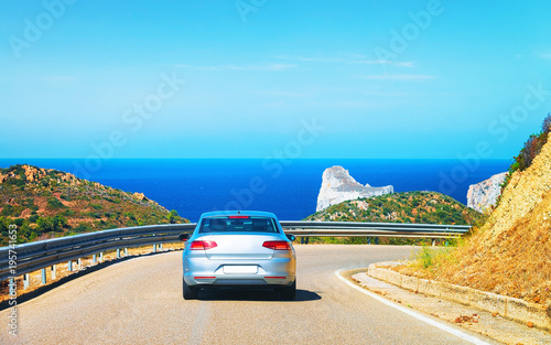 Car on road at Porto Corallo Nebida Mediterranean Sea Sardinia
