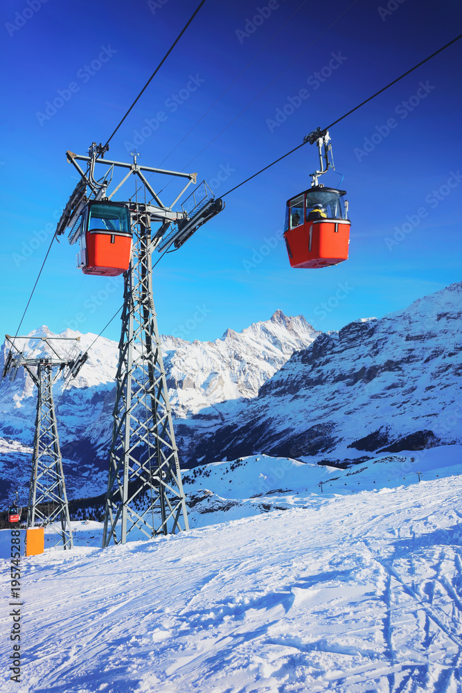 Obraz premium Cable car cabins at winter sport resort Swiss Alps Mannlichen