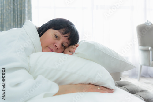 woman lies in bed