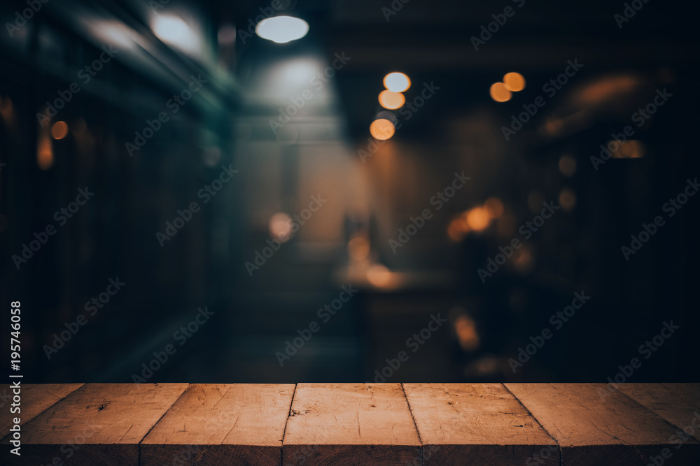 Wood table top on blurred of counter cafe shop with light bulb.Background for montage product display or design key visual - obrazy, fototapety, plakaty 