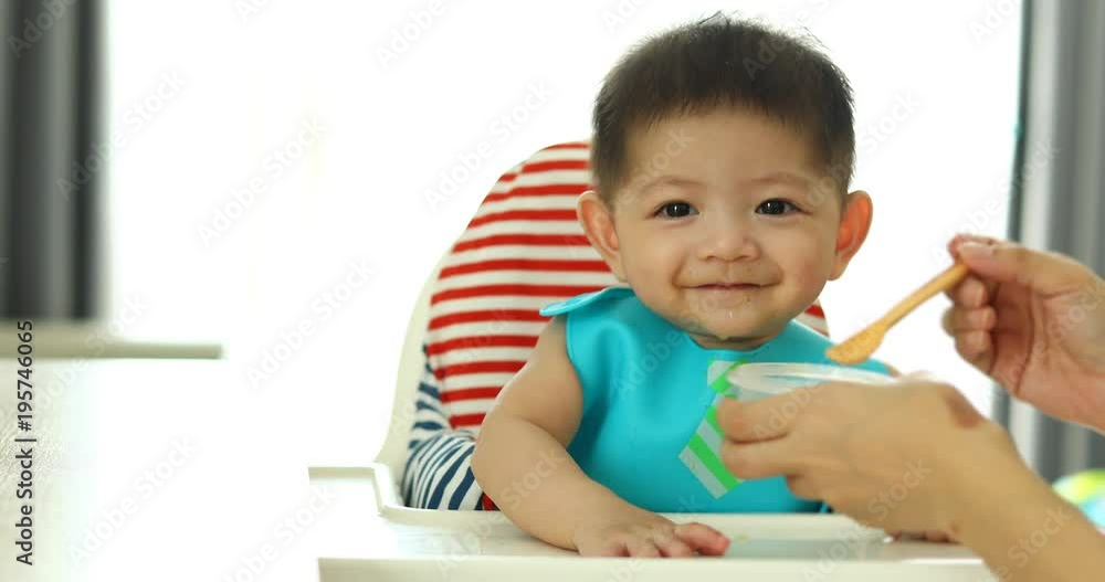 cute baby boy happy eating time with mother feeding soup tasty cute baby boy happy eating time with mother feeding soup tasty