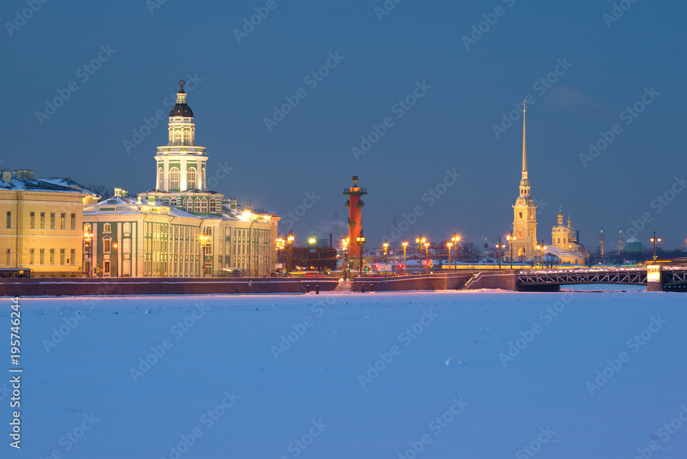 Rostral column and Peter and Paul Cathedral in February twilight. Saint-Petersburg, Russia