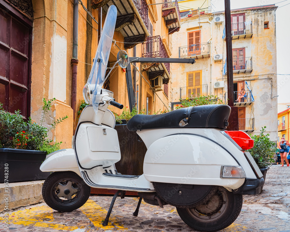 Scooter in street of Cefalu old town Sicily