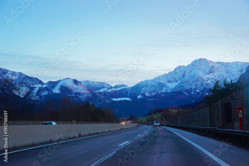 Road with view on Alpine mountains at Austria in evening