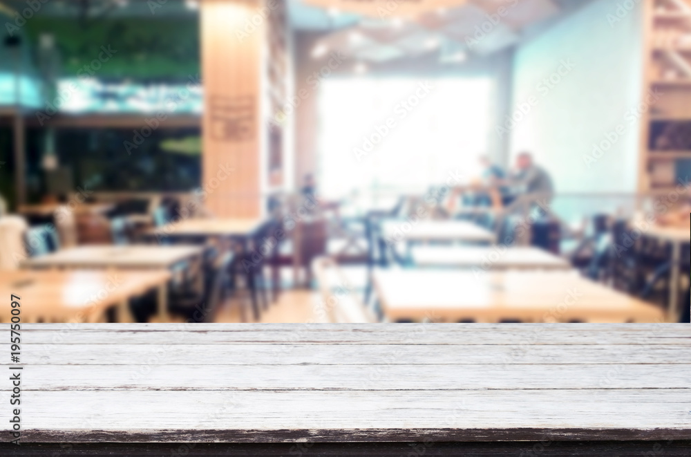 Selected focus empty brown wooden table and Coffee shop or restaurant blur background with bokeh image. for your photomontage or product display. Selected focus empty brown wooden table and Coffee shop or restaurant blur background with bokeh image. for your photomontage or product display.