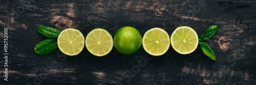 Fresh Green Lime. Fruits. On a wooden background. Top view. Copy space.