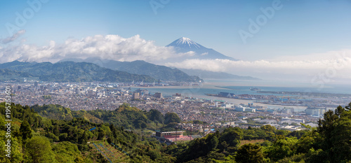 Panoramic view of Shizuoka city and Fuji mountain behind on cloudy day.