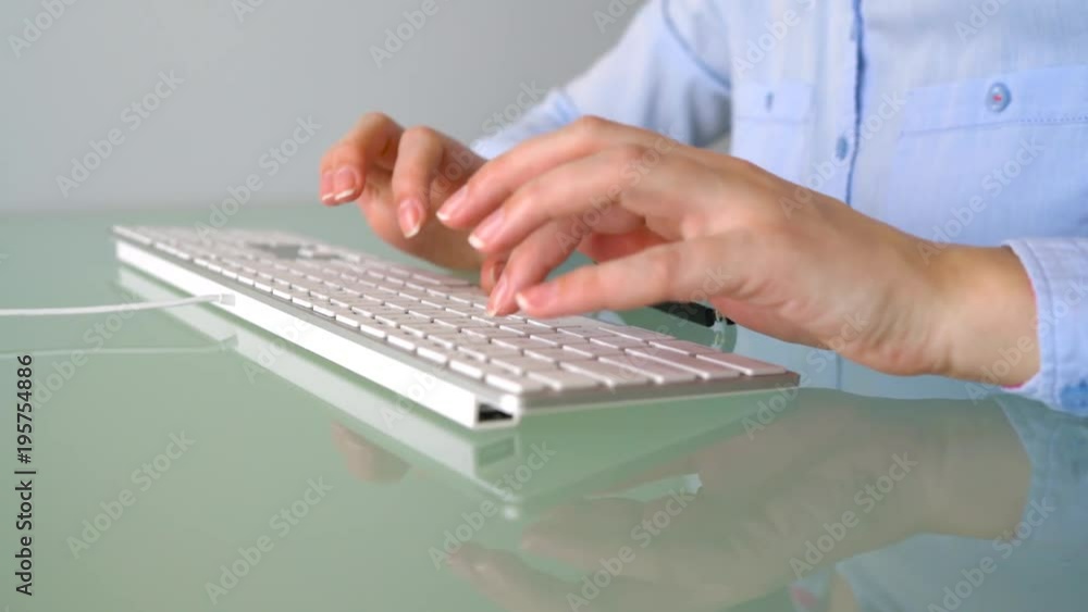 Woman office worker typing on the keyboard Woman office worker typing on the keyboard