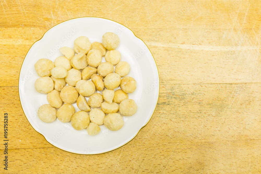 Plate with macadamia nuts. View from above. Plate with macadamia nuts. View from above.