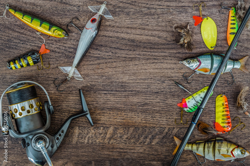 Fishing tackle on wooden background. Top view.