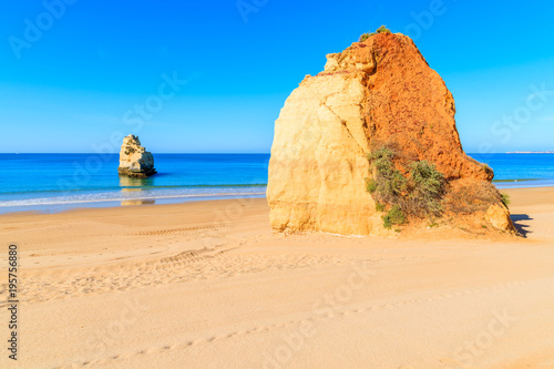Rocks on beautiful sandy Praia da Rocha beach in Portimao town, Algarve, Portugal
