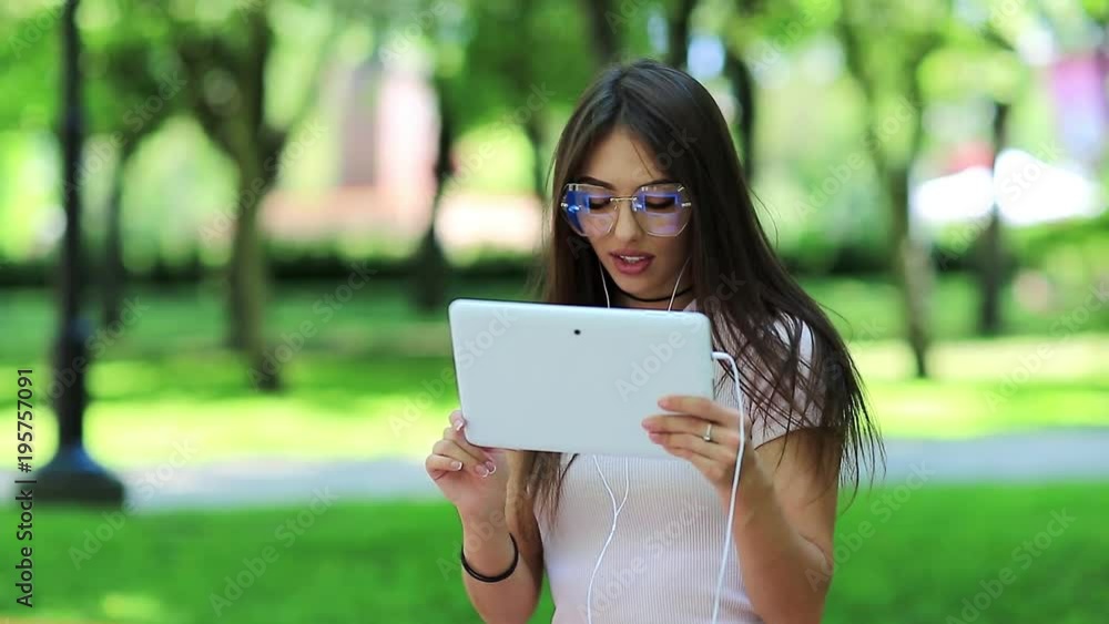 Girl uses tablet computer. Beautiful woman uses tablet pc. Attractive girl hold in hands white tablet pc Girl uses tablet computer. Beautiful woman uses tablet pc. Attractive girl hold in hands white tablet pc