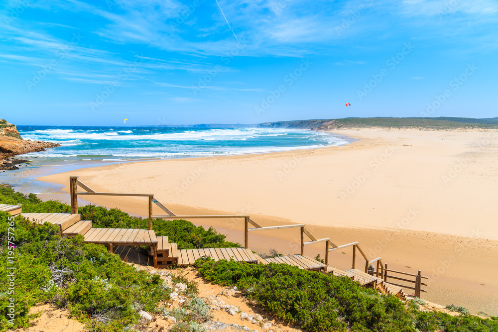 Wooden walkway to beautiful Praia da Bordeira beach, popular place to do kite surfing, Algarve, Portugal