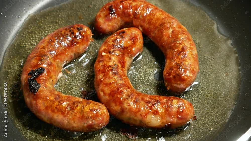 Overhead Closeup frying link sausage fast food in cast iron skillet Overhead Closeup frying link sausage fast food in cast iron skillet