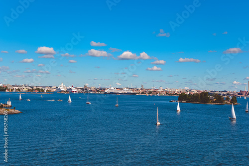 View of the city of Stockholm, Sweden, with floating boats on a sunny day against the background of a cloudy sky