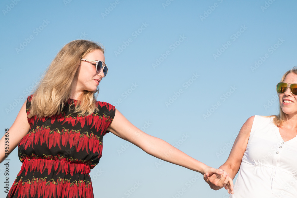 Two blond girls on the beach near sea Two blond girls on the beach near sea