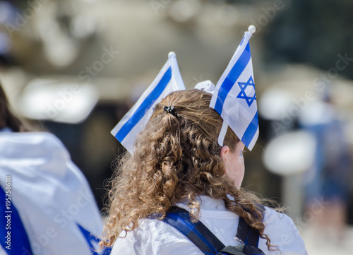 The patriotic girl with Israeli flag on his head celebrate Israel Independence day