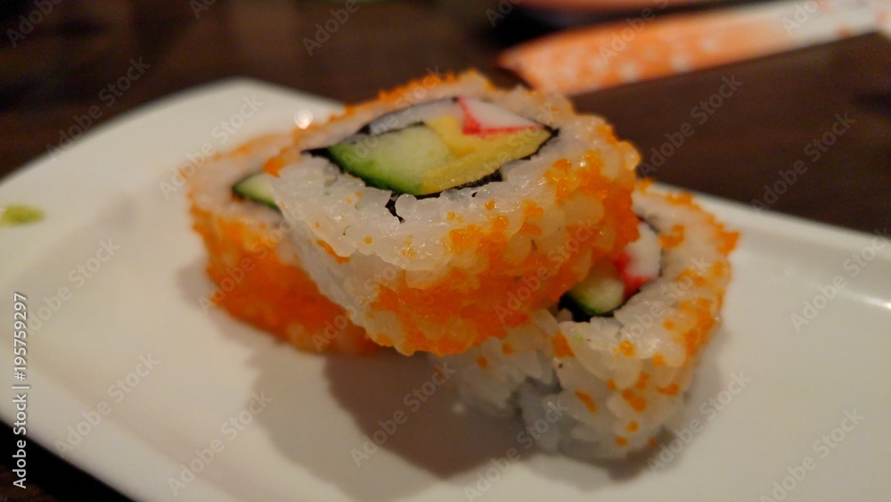 Sushi inside out with avocado, crab stick and omelette. Delicious sushi close up. Sushi inside out with avocado, crab stick and omelette. Delicious sushi close up.