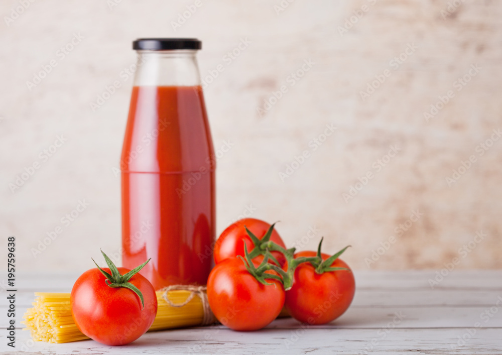 Glass bottle of tomato paste with raw spaghetti Glass bottle of tomato paste with raw spaghetti