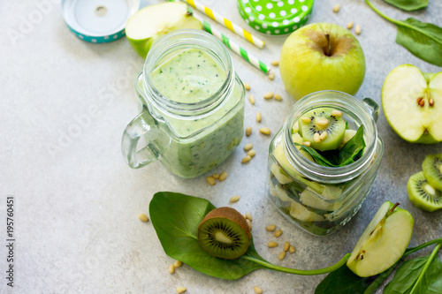 Green smoothies and apple, kiwi, spinach, pine nuts. Healthy vegan food concept. Copy space.