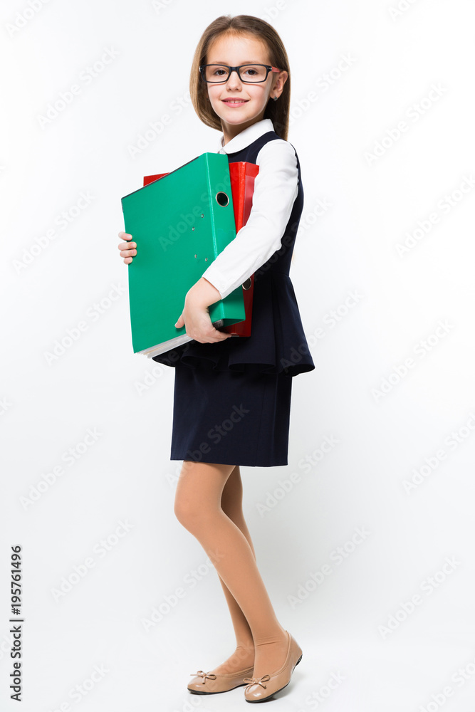 Little girl with binders in her hands dressed as a businesswoman Little girl with binders in her hands dressed as a businesswoman
