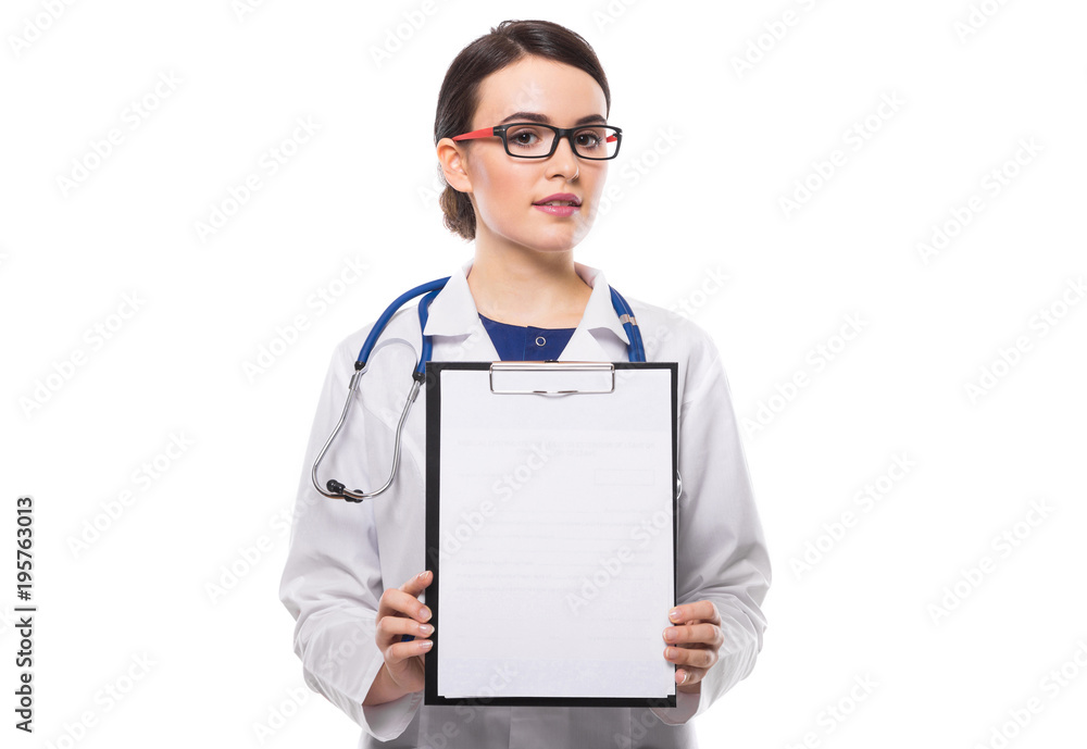 Young woman doctor with stethoscope holding and showing clipboard in her hands in white uniform on white background Young woman doctor with stethoscope holding and showing clipboard in her hands in white uniform on white background
