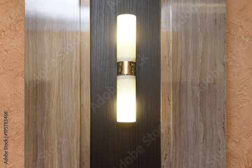 Beautiful vertical sconce on the wall in the hall photo