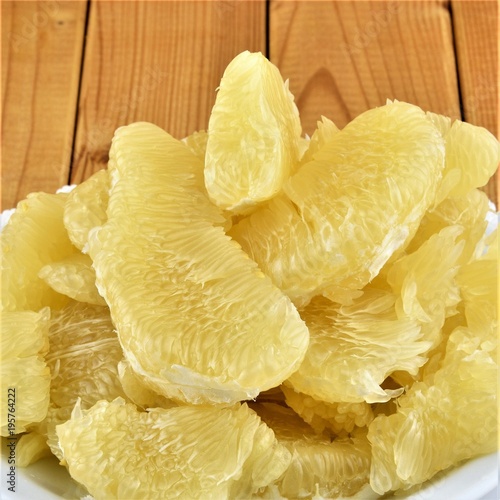 Flesh of fresh yellow pomelo on the wooden background photo