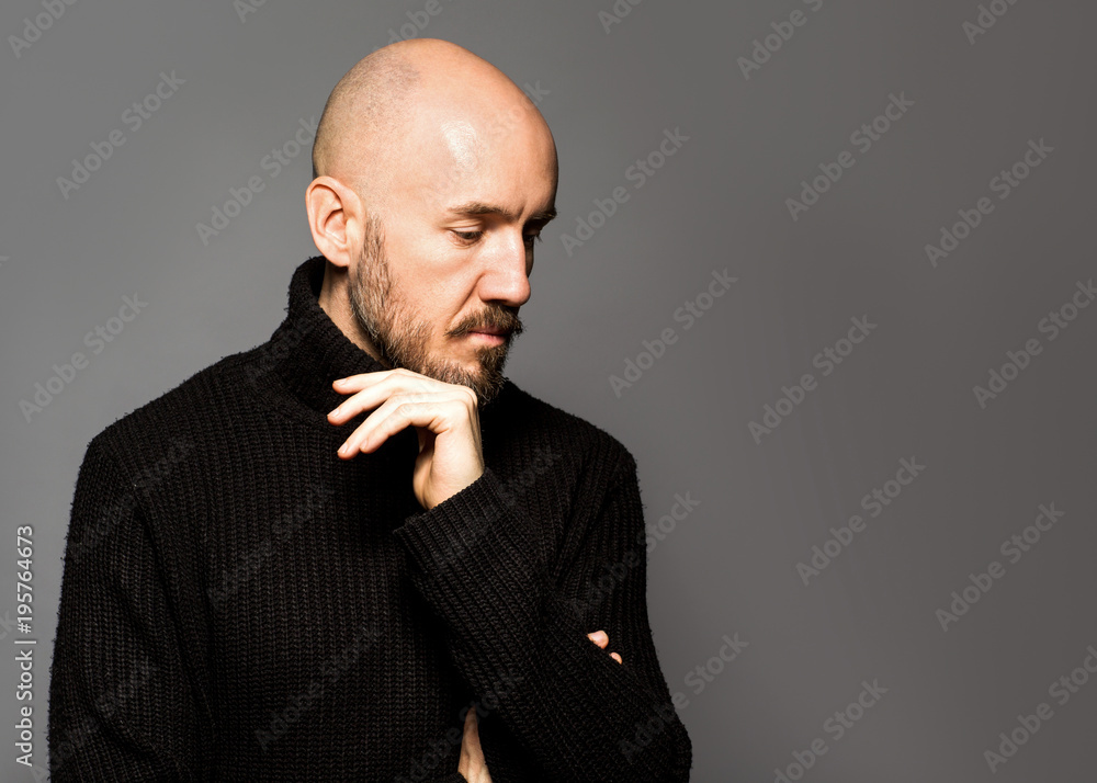 Fashion Portrait of a 40-year-old man standing over a light gray background  in a black sweater. Close up. Classic style. Bald shaved head. Copy-space.  Studio shot Stock Photo | Adobe Stock