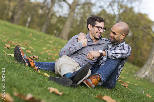 gay couple sitting together in the park