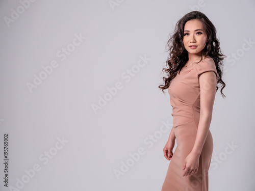 Beautiful Female Asian Model in studio on white background with negative space photo