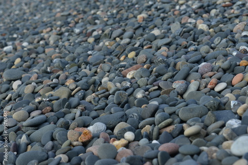 Pebble beach, Jersey, U.K. Abstract image of grey slate stones.